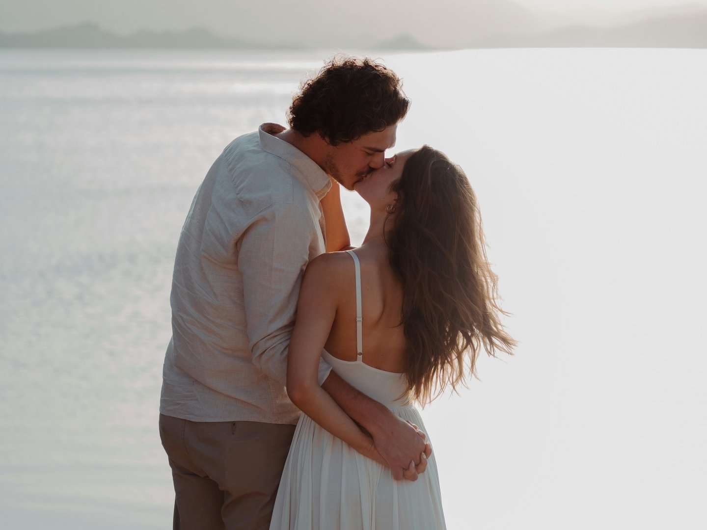 Couple on beach looking at ocean